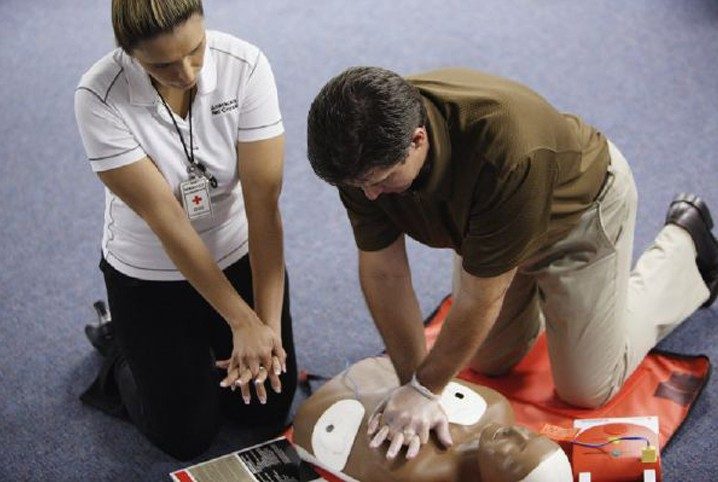 person learning CPR from trainer